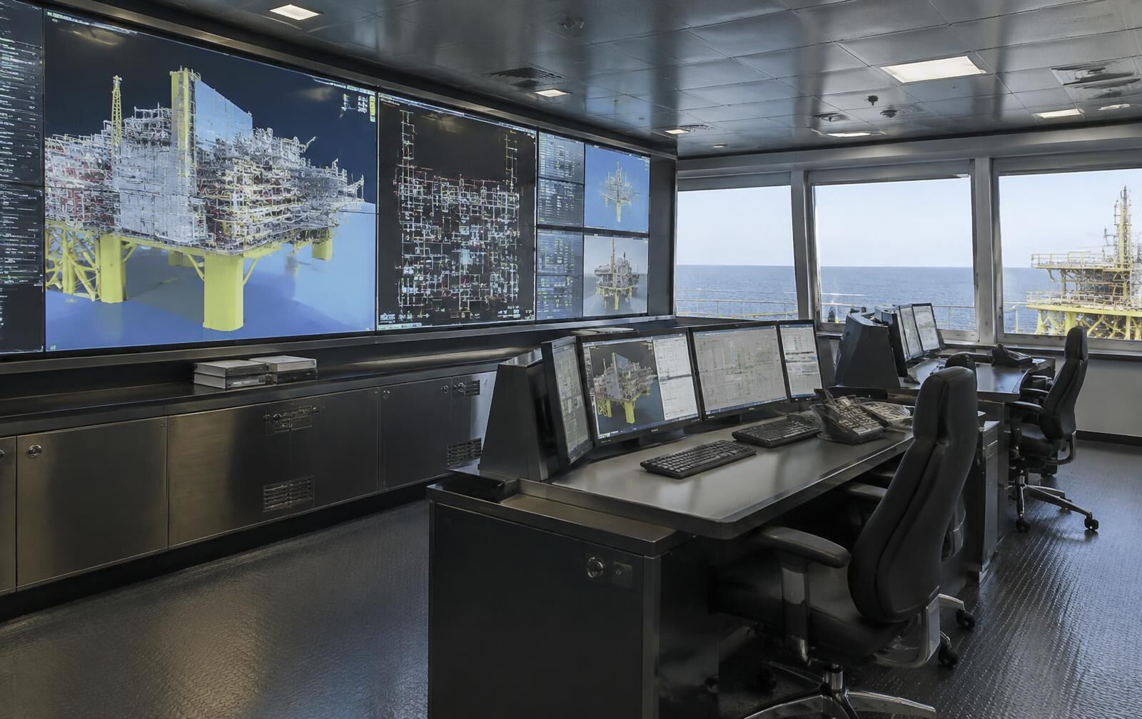 Unmanned offshore engineering control room displaying platform models