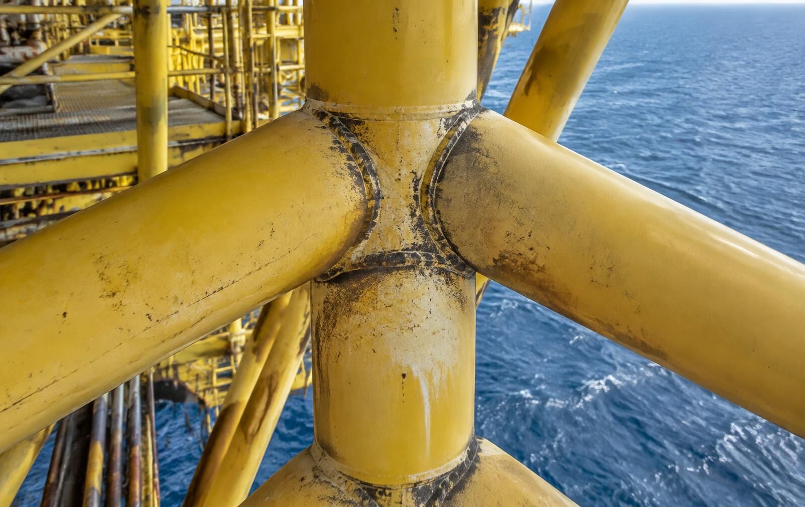 Welded tubular structural nodes on an offshore platform above open sea in daylight